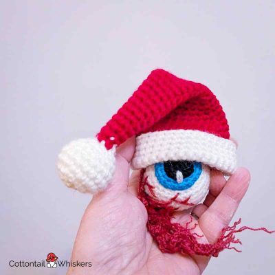Eyeball with a free christmas crochet santa hat pattern by cottontail and whiskers