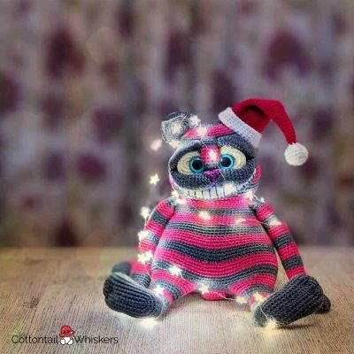 Cheshire cat with a free christmas crochet santa hat pattern by cottontail and whiskers