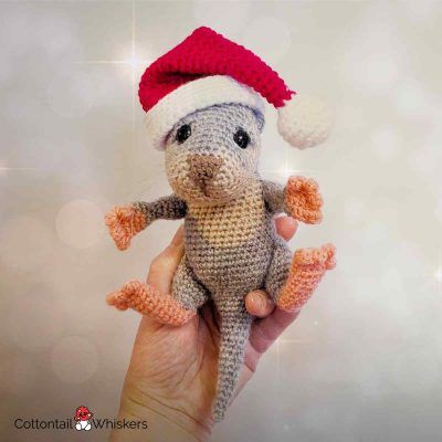 Baby otter with a free christmas crochet santa hat pattern by cottontail and whiskers